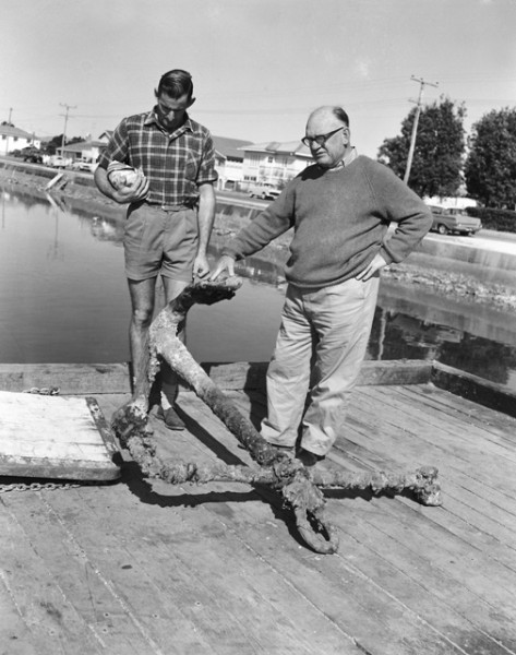 John Smith and Phil Swales inspect an anchor, believed to be from the Scottish Prince, found off Main Beach, Southport, Queensland, 1964 Bob Avery, photographer