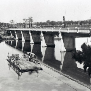 Vehicle Ferry on the Coomera River with the new bridge near completion circa 1930 Photographer unknown