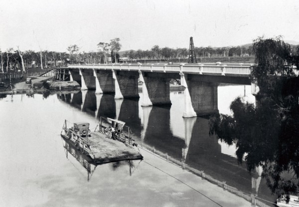 Vehicle Ferry on the Coomera River with the new bridge near completion circa 1930 Photographer unknown