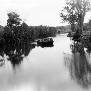 Barge used in the construction of the bridge across the Nerang River at Nerang, Queensland, heading downriver circa 1930s George A Jackman photographer